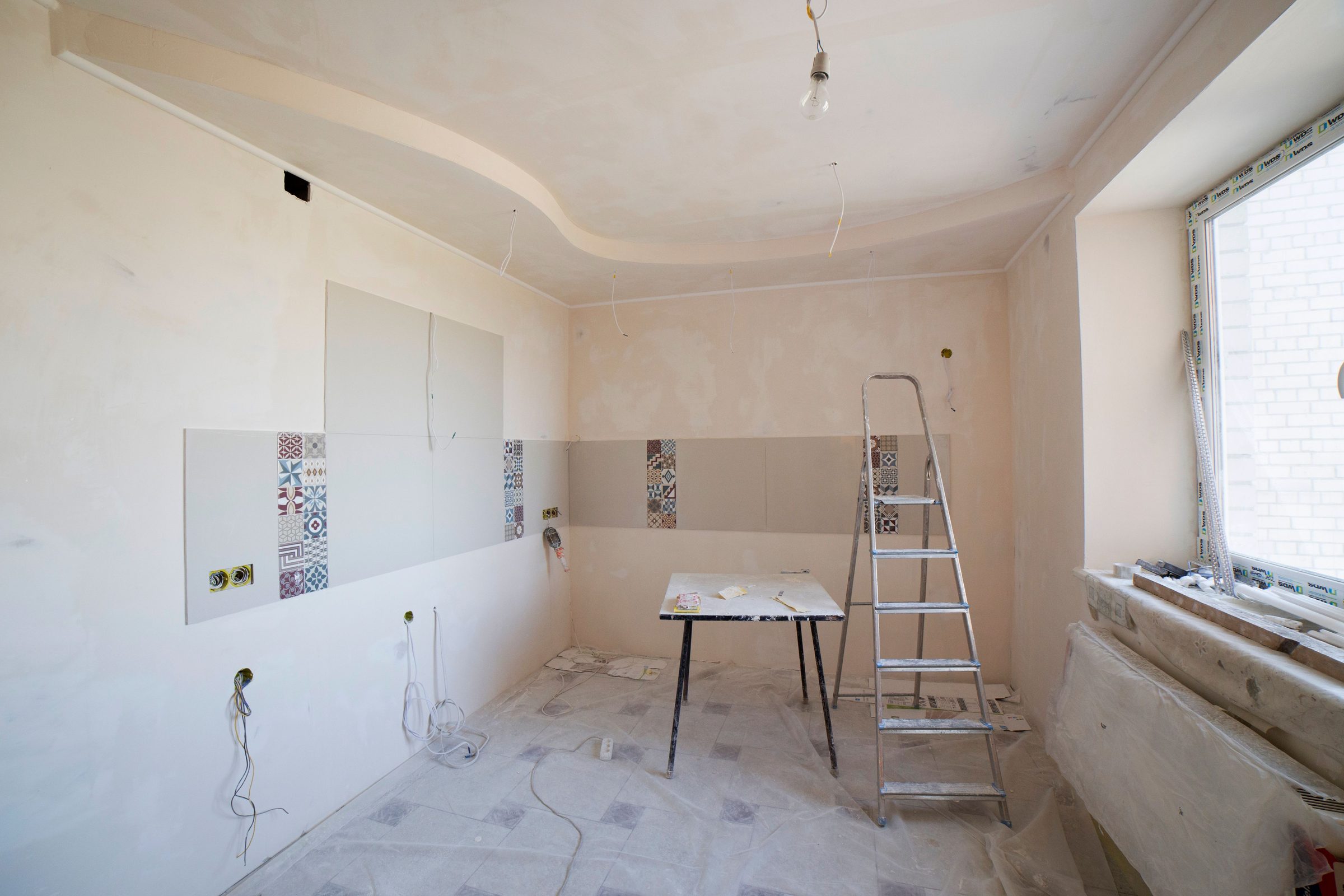 Room mid-renovation with fresh tiling and plasterwork